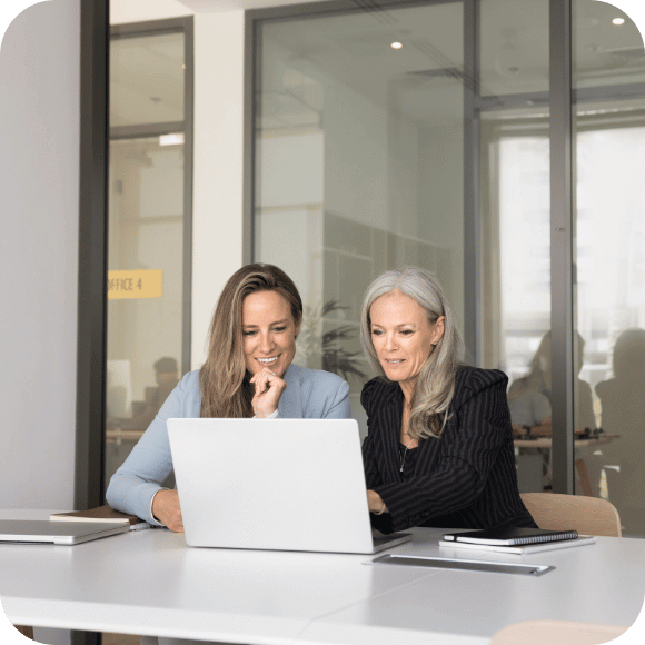 Two people looking at a laptop.