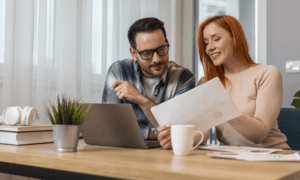Two people looking at a paper