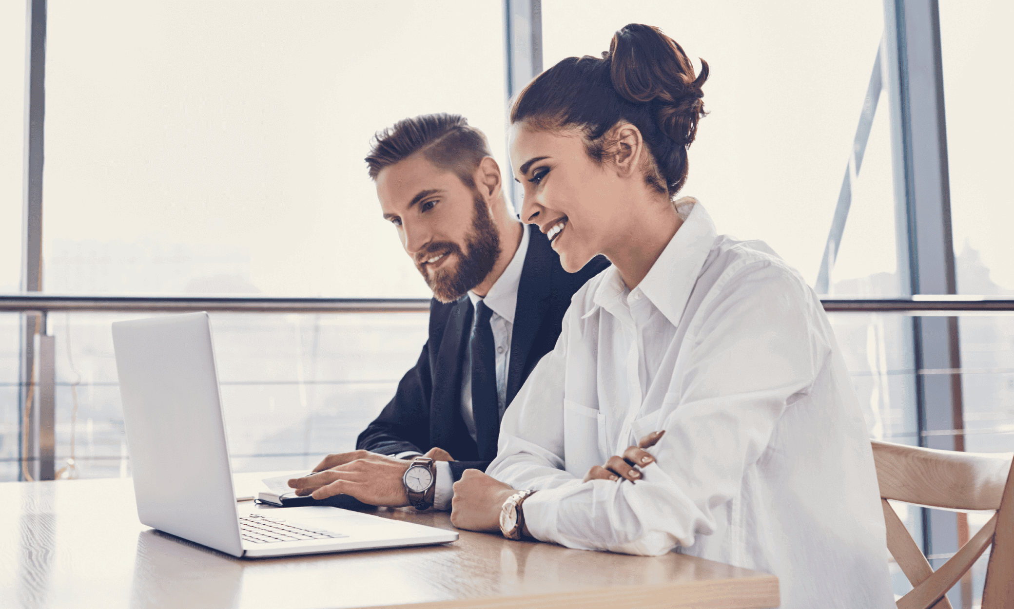 Two people looking at a laptop.